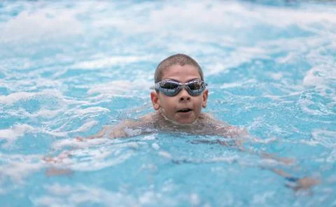 Boy swimming in pool Stock Photos