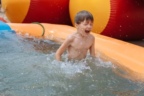 The boy is swimming in the pool Stock Photos