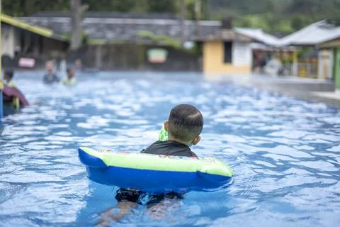 Boy swimming in a pool Stock Photos