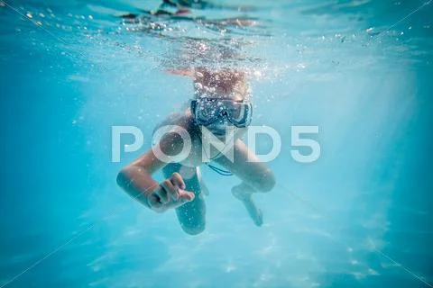 Boy swimming under water Stock Photos