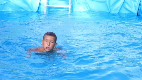 The boy swims beautifully in the pool Stock Footage 315030581