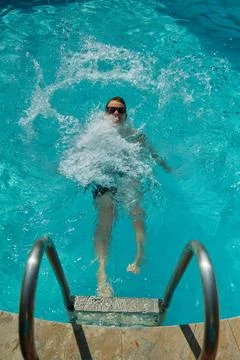 A boy swims in the pool 스톡 사진