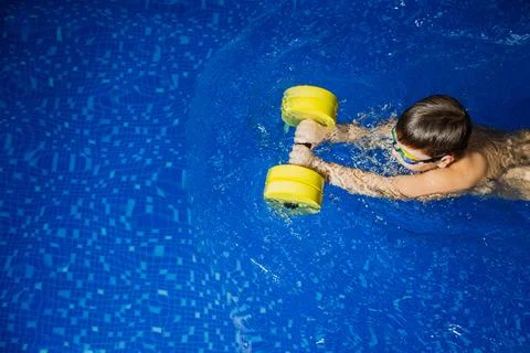 Boy swims in the pool 스톡 사진