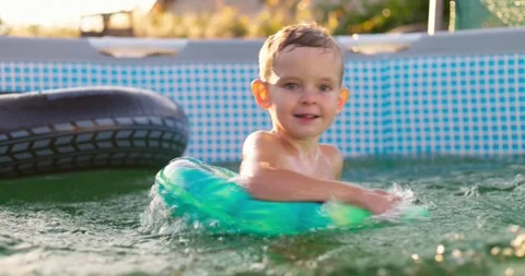 Boy swims in swimming pool on inflatable ring. Stock Footage 246826267