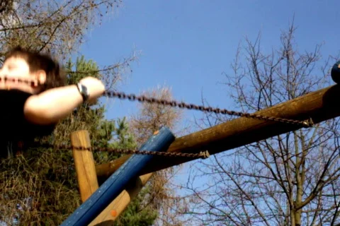 Boy on a swing loopable, slow motion shot at 60 fps Stock Footage 667325