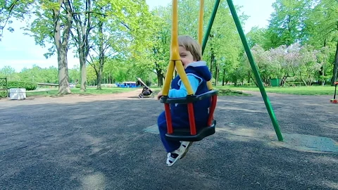 Boy on a swing in the park Video stock 154514654