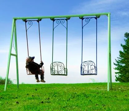 Boy on swing Stock Photos