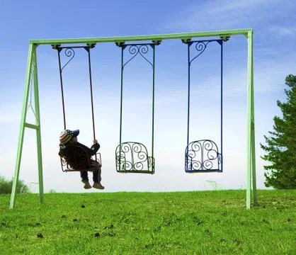 Boy on swing Stock Photos