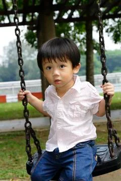 Boy on a swing Stock Photos