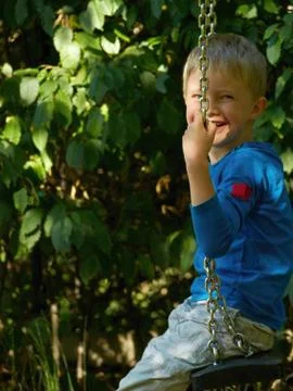 Boy on swing Stock Photos