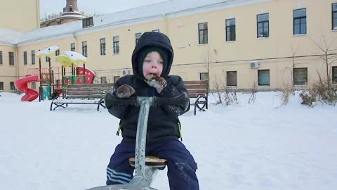 A boy on a swing in winter Stock Footage 166643401