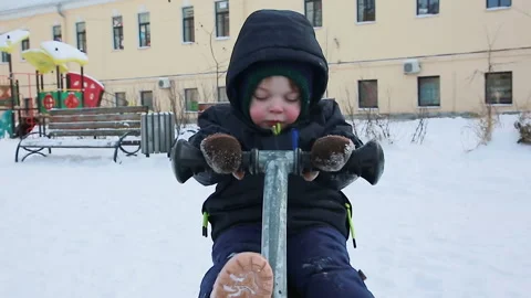 A boy on a swing in winter Video stock 167014645