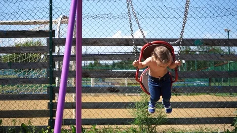 Boy swinging in park Stockbeeldmateriaal 111472789