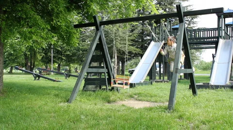 Boy swinging on a swing Stock Footage 5295165