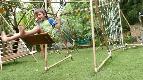 Boy swinging on a swing 库存影片 65332323