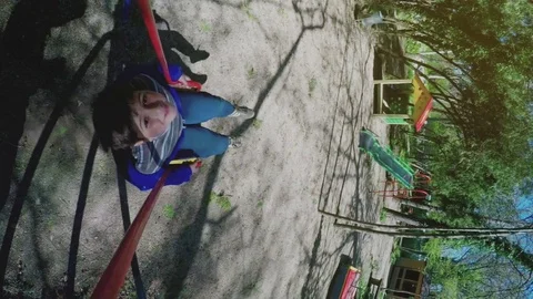 Boy swinging on a swing - side view Stock Footage 75609789