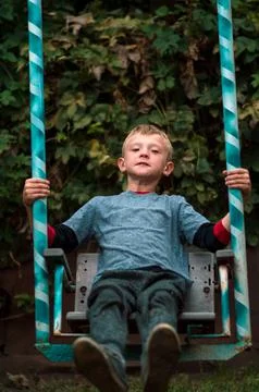 A boy swings Stock Photos