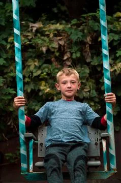 A boy swings Stock Photos