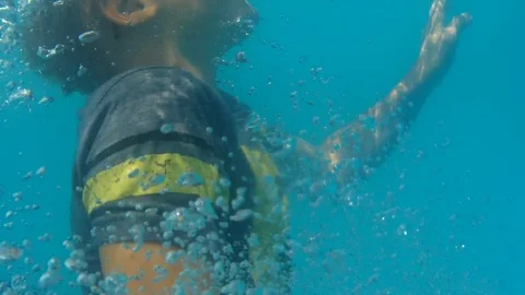 Boy in T-shirt tries to swim out of the pool Stock Footage 123745775