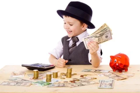 Boy at the table counts money Stock Photos
