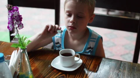 Boy at the Table Drinking Tea Stock Footage 64324597