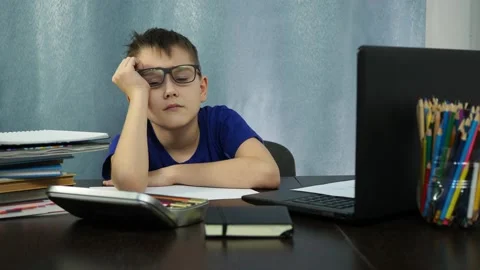 The boy at the table falls asleep over home lessons. study at home Stock Footage 145210429
