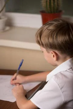 The boy at the table Stock-Fotos