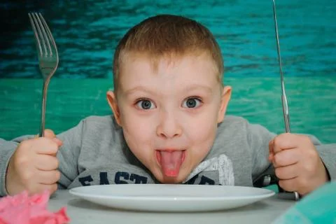 A boy at a table in a pizzeria Stock Photos