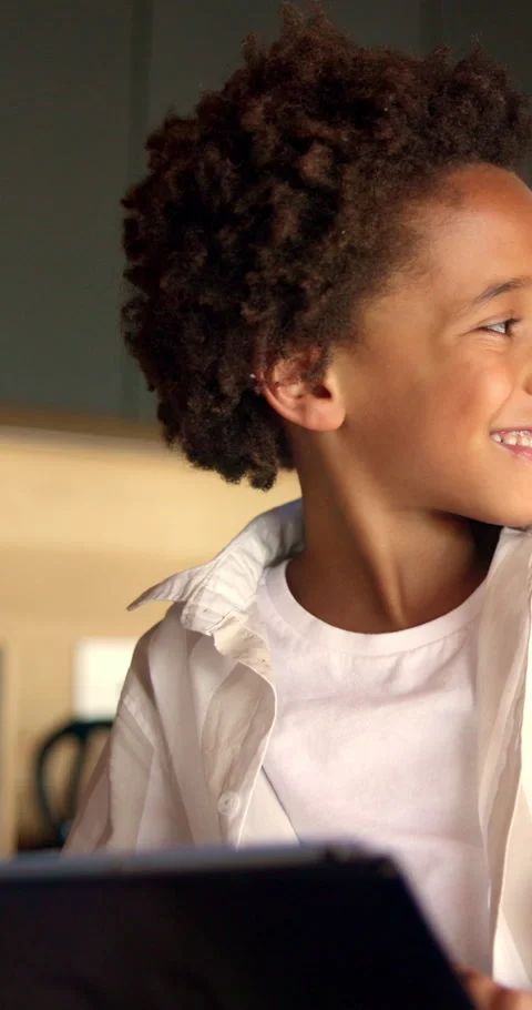 Boy, tablet and smile with typing in home for educational games, puzzle app and Stock Footage 343247083