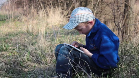 Boy with a tablet in autumn Stock Footage 255895109