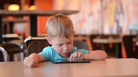 Boy with the tablet in cafe. 60fps Video stock 62514657