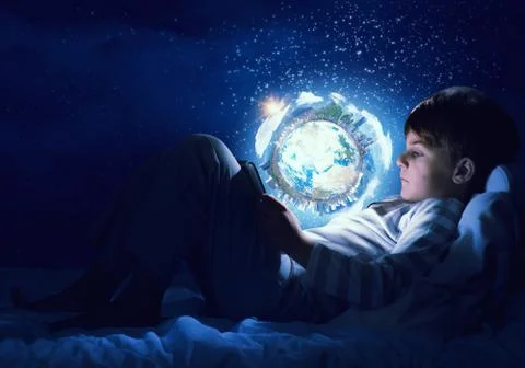 Boy with tablet in his bed Stock Photos