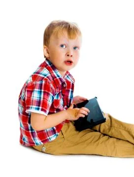 Boy with a Tablet PC sitting on the floor Stock Photos