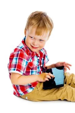 Boy with a Tablet PC sitting on the floor Stock Photos