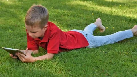 Boy  with a tablet Stock Photos