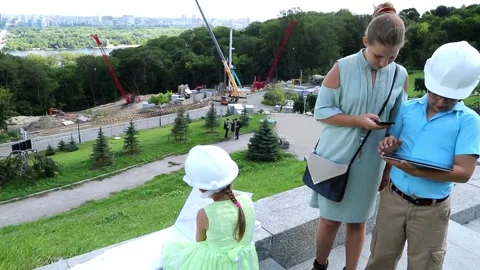 The boy on the tablet shows the construction process Stock Footage 97266454