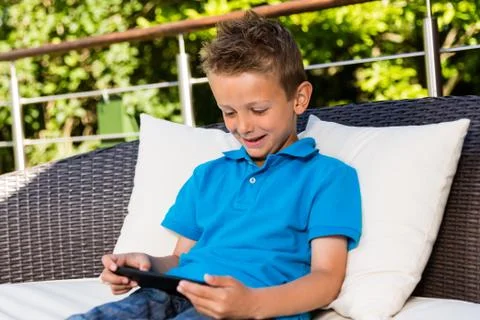 Boy with tablet at terrace Stock Photos