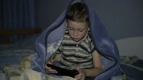 The boy with the tablet under the blanket Stock Footage 61700249