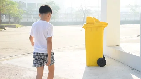 Boy take garbage bag from yellow bin Stock Footage 59764510