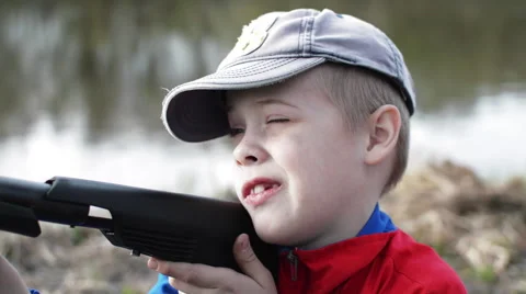 Boy Takes Aim at the Gun Stock Footage 62776614