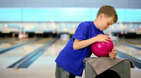 Boy takes ball and throws it to beat skittles on bowling lane 動画素材 11045683
