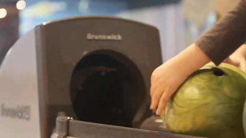 Boy takes a ball with storage balls for bowling Stock Footage 88832030
