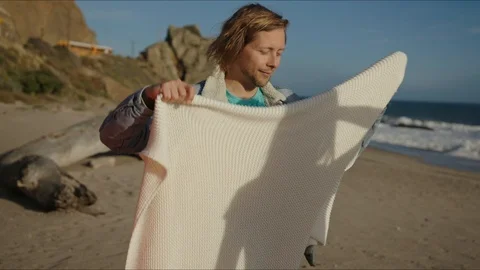 Boy takes care about his girlfriend and hugs her with a plaid Stock Footage 127409974