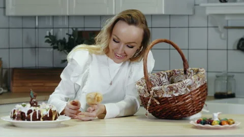 A boy takes an Easter newborn chick out of a basket. Stock Footage 303622231