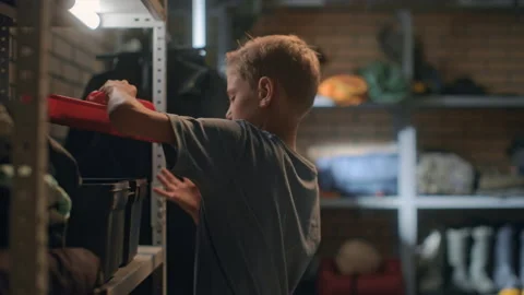 Boy takes instruments from tool box in garage. Child repairing machine mechanism Video stock 199485850