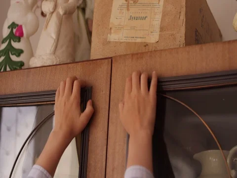 The boy takes an old box from the cupboard Stock Footage 80500547