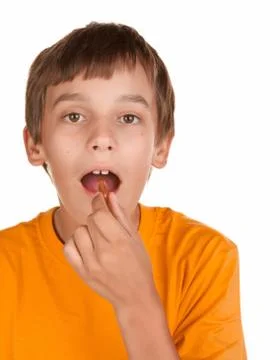 Boy taking a pill Stock Photos