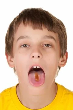 Boy taking a pill Stock Photos