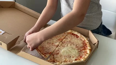 Boy taking pizza slice from the box. Stock Footage 156343103