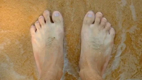 A boy is taking a sand on the foot Stock Footage 85397387